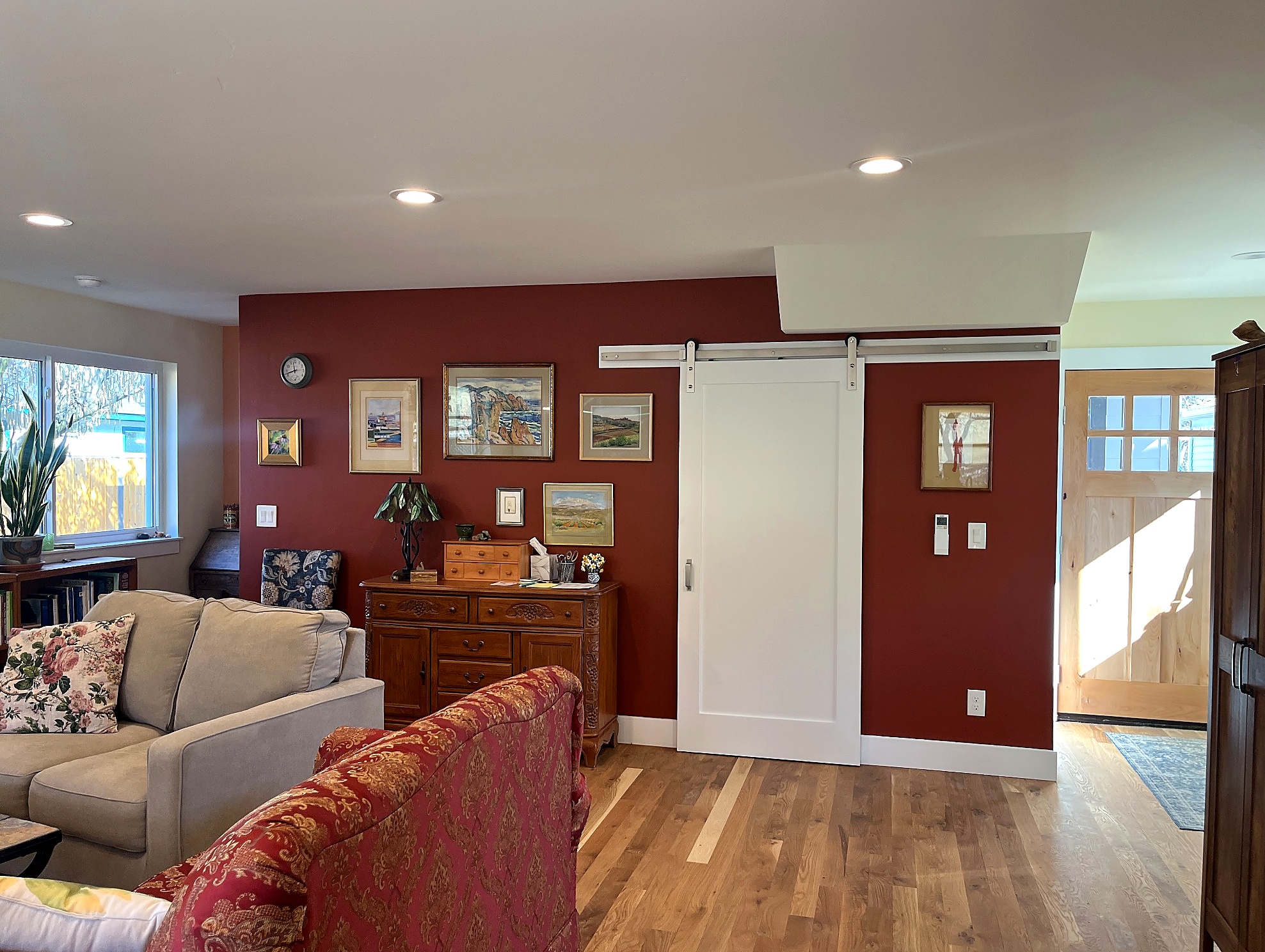 Brookman ADU accent wall with barn-door storage.